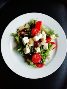 pexels-photo-1211887-1211887 Delicious Greek salad featuring fresh vegetables and creamy feta cheese, perfect for a healthy meal.